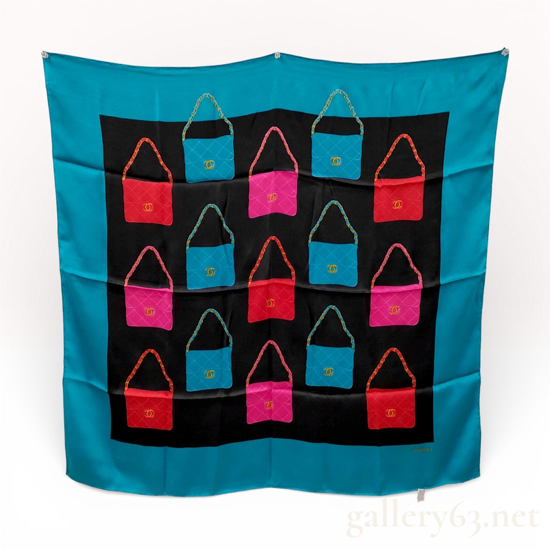 Chanel Vintage Matelasse Silk Scarf with Flap Bag Motif 92 x 86cm: Authentic Chanel silk scarf crafted in vibrant turquoise featuring a central graphic panel of stylized quilted handbag motifs in pink, red, and blue. Design incorporating subtle interlocking CC Coco M