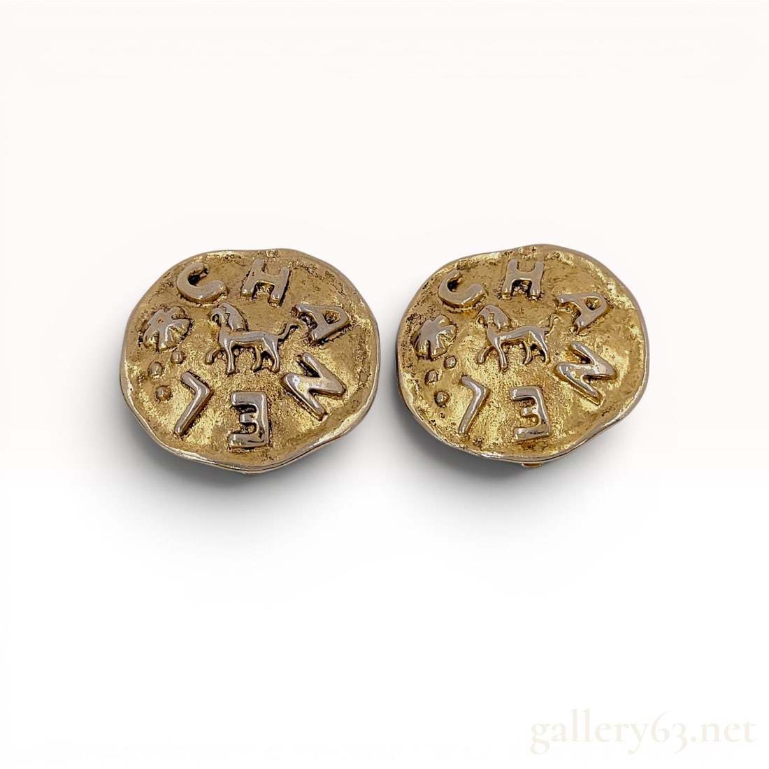 A Pair of Vintage Chanel 1986 Two-Tone Coin-Style Clip-On Earrings w/Box: Chanel vintage Season 23 coin-style clip-on earrings, circa 1986. Constructed from two-tone gold and silver-plated base metal with a hammered texture, the design features a central animal motif surrou