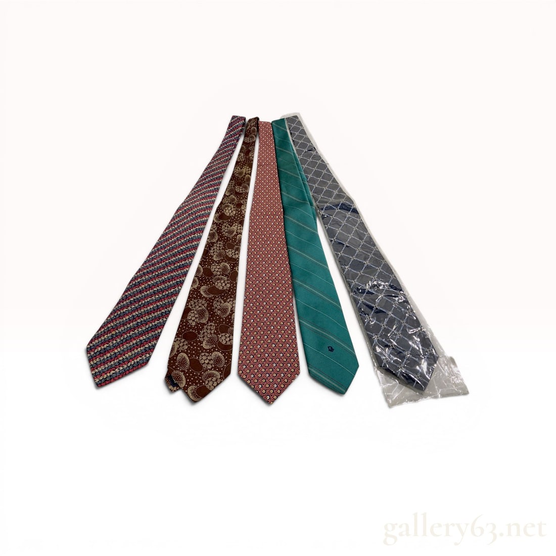 A Collection of 5 Christian Dior and Gucci Designer Neckties: A collection of 5 designer neckties by Christian Dior and Gucci featuring diagonal stripes, floral motifs, abstract paisley, and a chain-link lattice. Materials include silk and a blend of 95% polyest