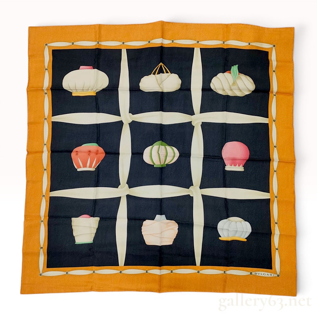 BVLGARI Davide Pizzigoni Turban Pattern Silk Scarf: Silk twill square scarf designed by Davide Pizzigoni for Bulgari. The composition features a navy blue center divided by cream-colored ribbon bands into a nine-square grid containing unique stylized t