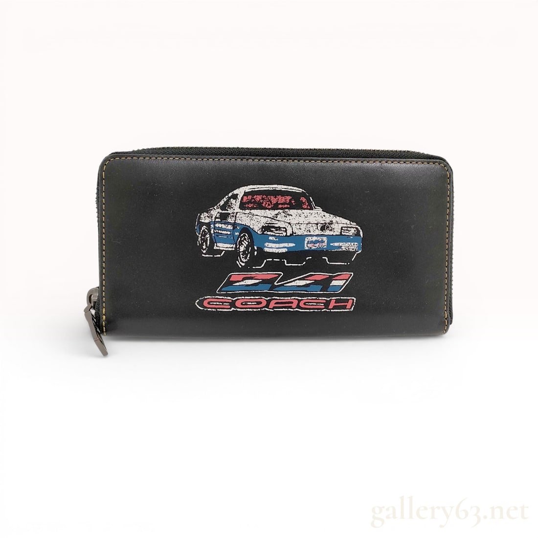 Coach 1941 Black Leather Racing Car Accordion Zip Wallet: This Coach accordion zip-around wallet is crafted from smooth black leather featuring contrast yellow topstitching and gunmetal-tone hardware. The front is decorated with a screen-printed racing car g