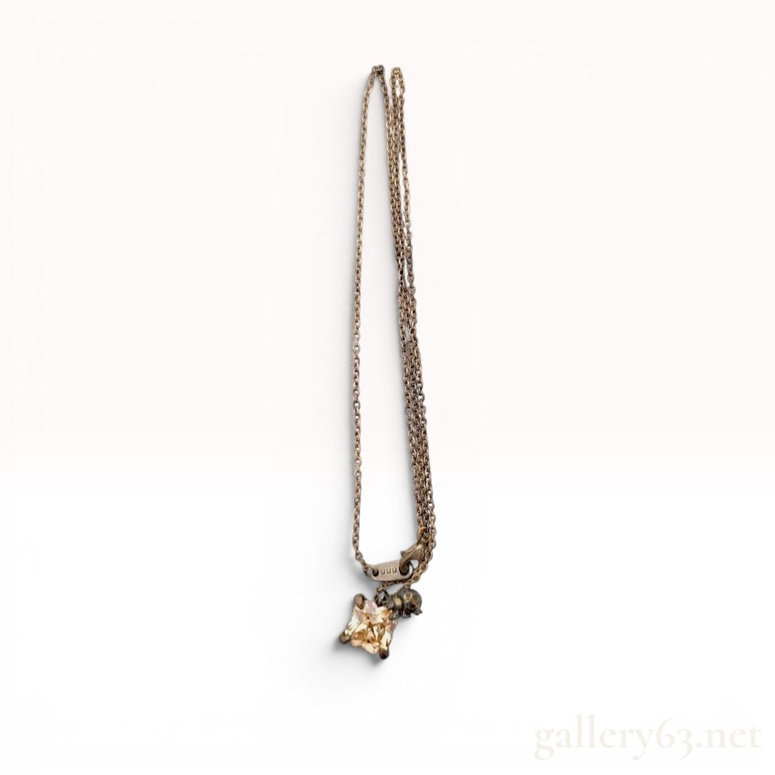 Sterling Silver Beetle and Square Cut Champagne Gemstone Pendant Necklace: Sterling silver pendant necklace featuring an antiqued finish and a whimsical beetle motif. The central pendant holds a square-cut faceted pale champagne gemstone in a four-prong cage setting, accente