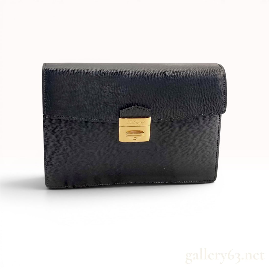 S.T. Dupont Paris Black Textured Leather Structured Clutch Bag: S.T. Dupont Paris structured accordion-style clutch bag in black cross-grain textured leather. The design features a front flap with a polished gold-tone push-lock clasp and two expandable interior co