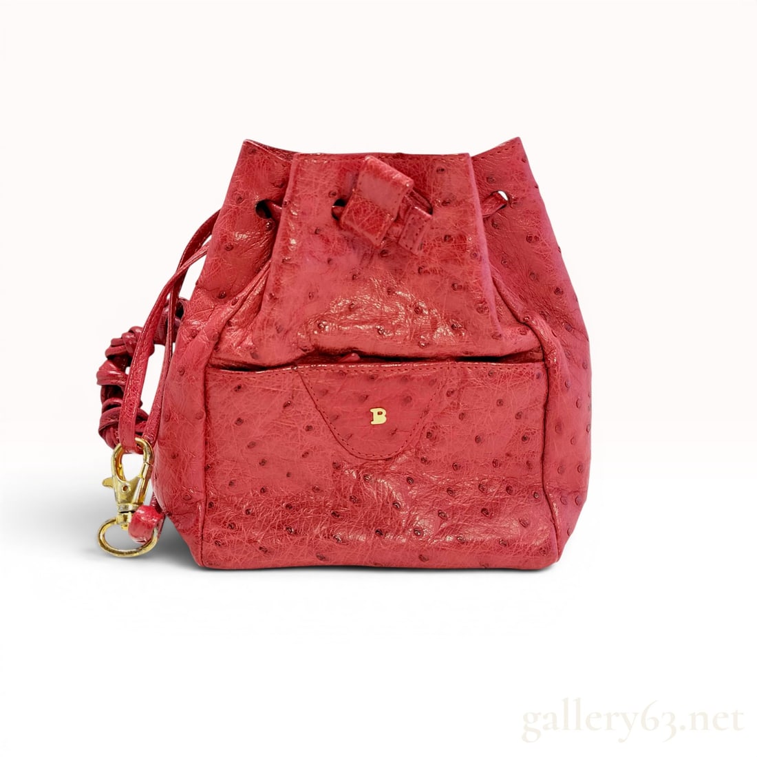 Made in West Germany Bally Red Ostrich Leather Drawstring Bucket Bag: Vintage Bally drawstring bucket bag, circa mid-to-late 20th century. Crafted from red ostrich leather with a coordinating interior, the bag features a front slip pocket accented with a gold-tone B log