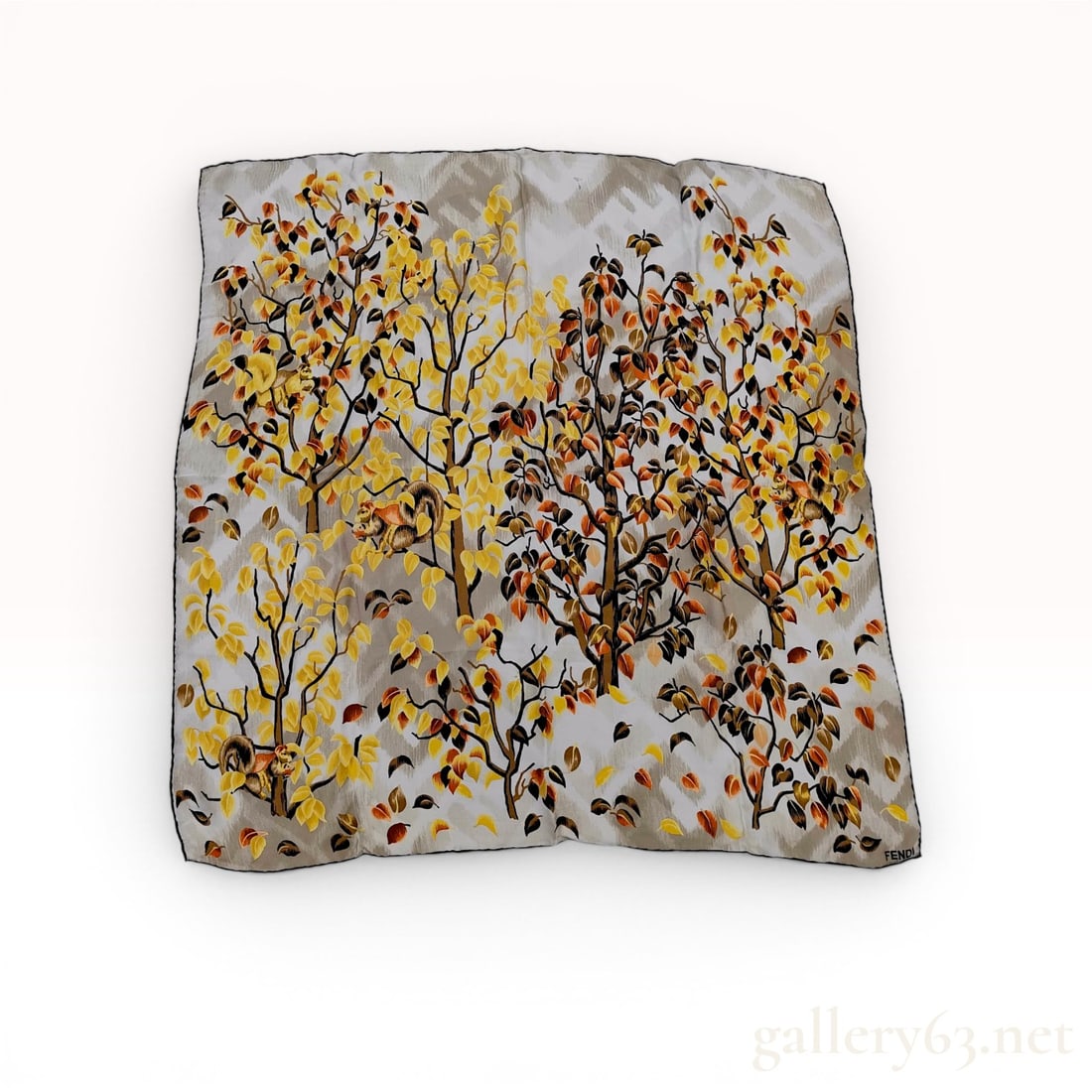 Fendi Autumn Forest and Squirrel Motif Silk Square Scarf with Storage Pouch: A Fendi square silk scarf featuring a screen-printed autumnal forest theme. The design illustrates multiple trees with foliage in yellow, orange, and brown tones, with small squirrels integrated into 