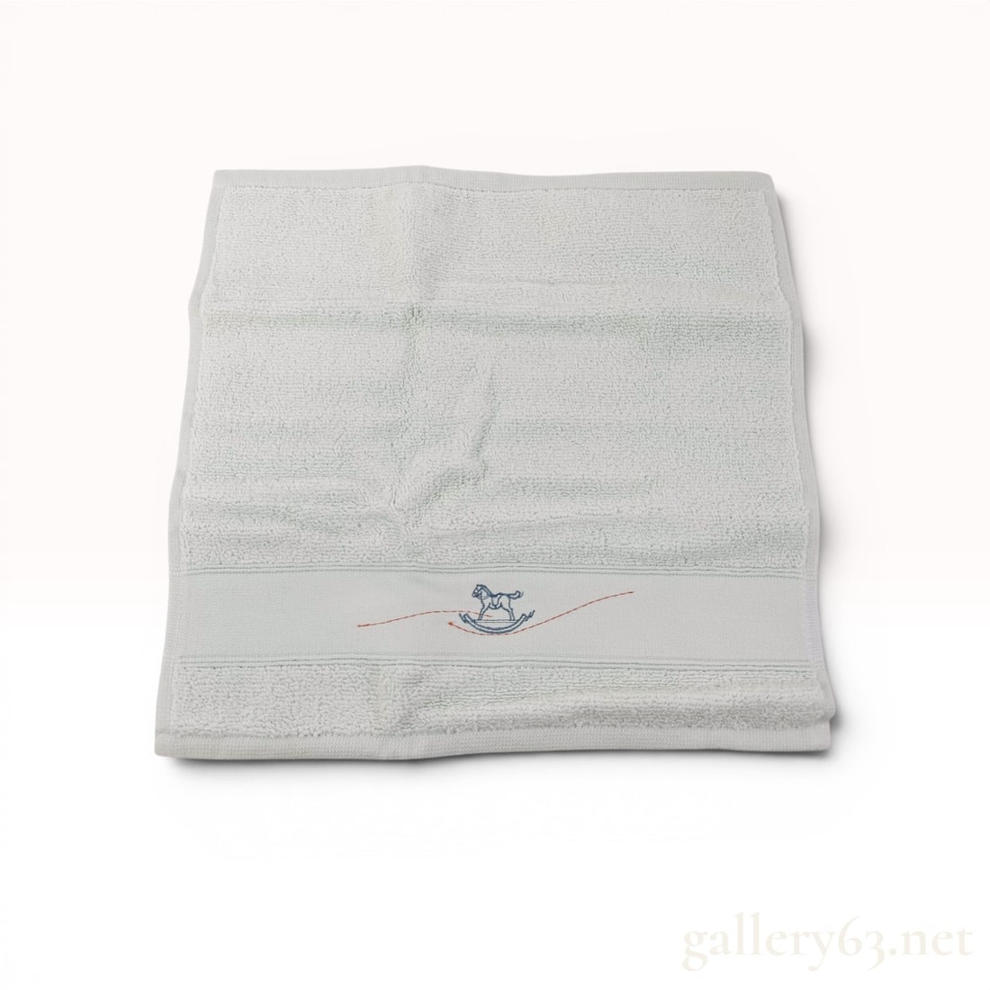 Hermes O Galop! Cotton Baby Towel New With Box & Tags: Herm?¨s O Galop! collection hand towel in Bleu Geni?¨vre P??le, modern. The piece is crafted from 100% zero-twist combed cotton and features an embroidered blue rocking horse motif with a single red