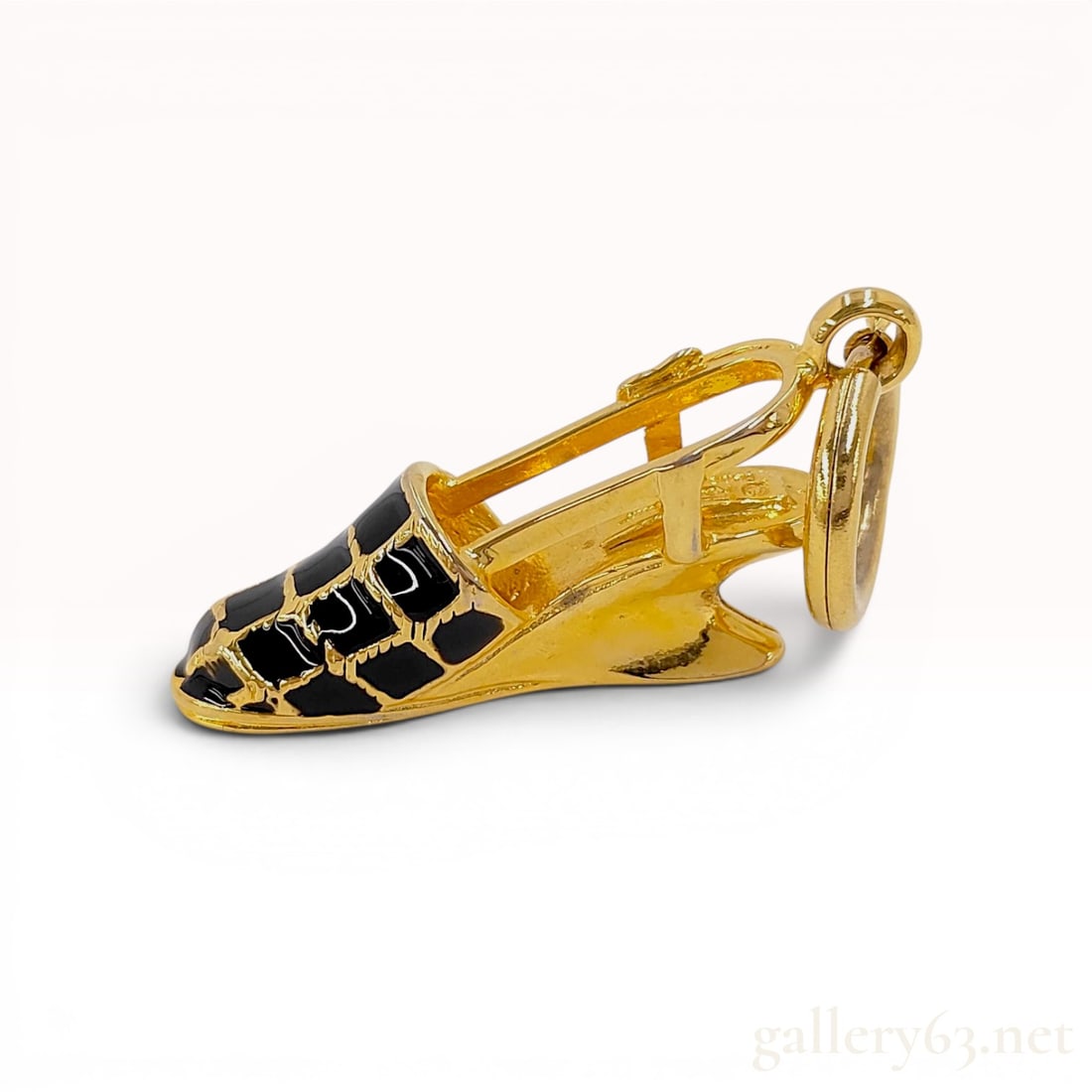 Salvatore Ferragamo Black Enamel and Gold-Tone Shoe Charm Pendant: Salvatore Ferragamo miniature shoe charm pendant, Italy. The piece is crafted from gold-tone metal in the form of a slingback wedge sandal, featuring a black enamel quilted lattice pattern on the toe 