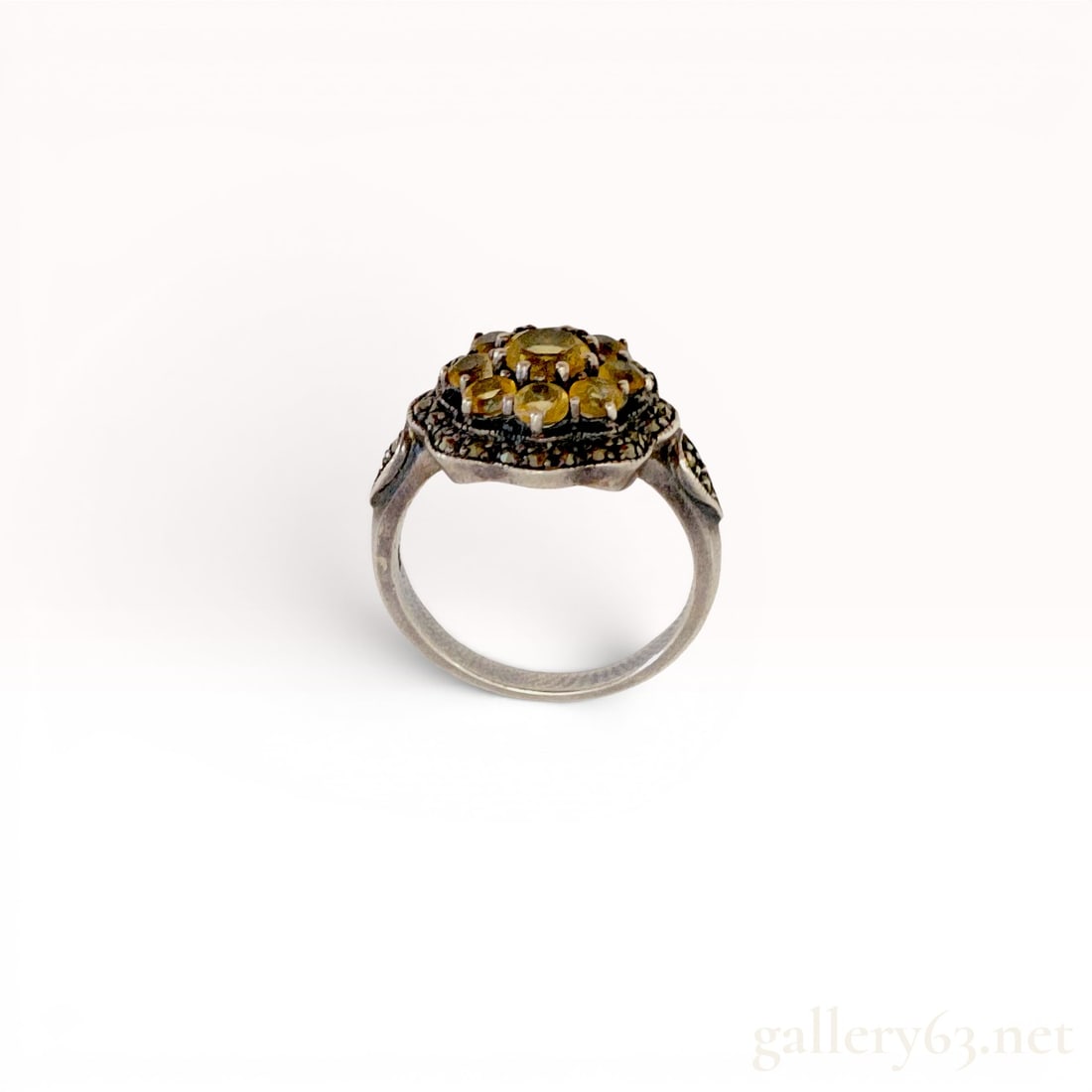 Art Deco Style Sterling Silver Cluster Ring with Yellow Stones and Marcasite: Art Deco revival sterling silver cocktail ring featuring a floral cluster of nine round faceted yellow stones, possibly citrine or yellow glass, secured with prong settings. The central design is bord