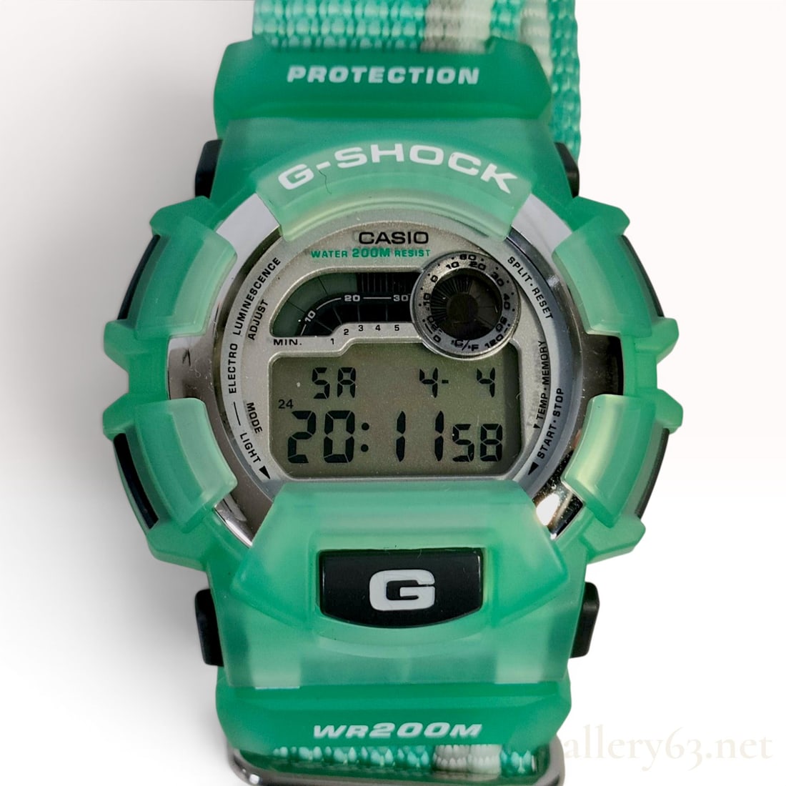 Casio G-Shock DW-8800 US Open Surfing Special Edition Digital Wristwatch w/Box: Casio G-Shock DW-8800 digital wristwatch, US Open Surfing special edition, circa 1998. The watch features a translucent green resin case and a teal woven nylon strap with a grey and white stripe and d