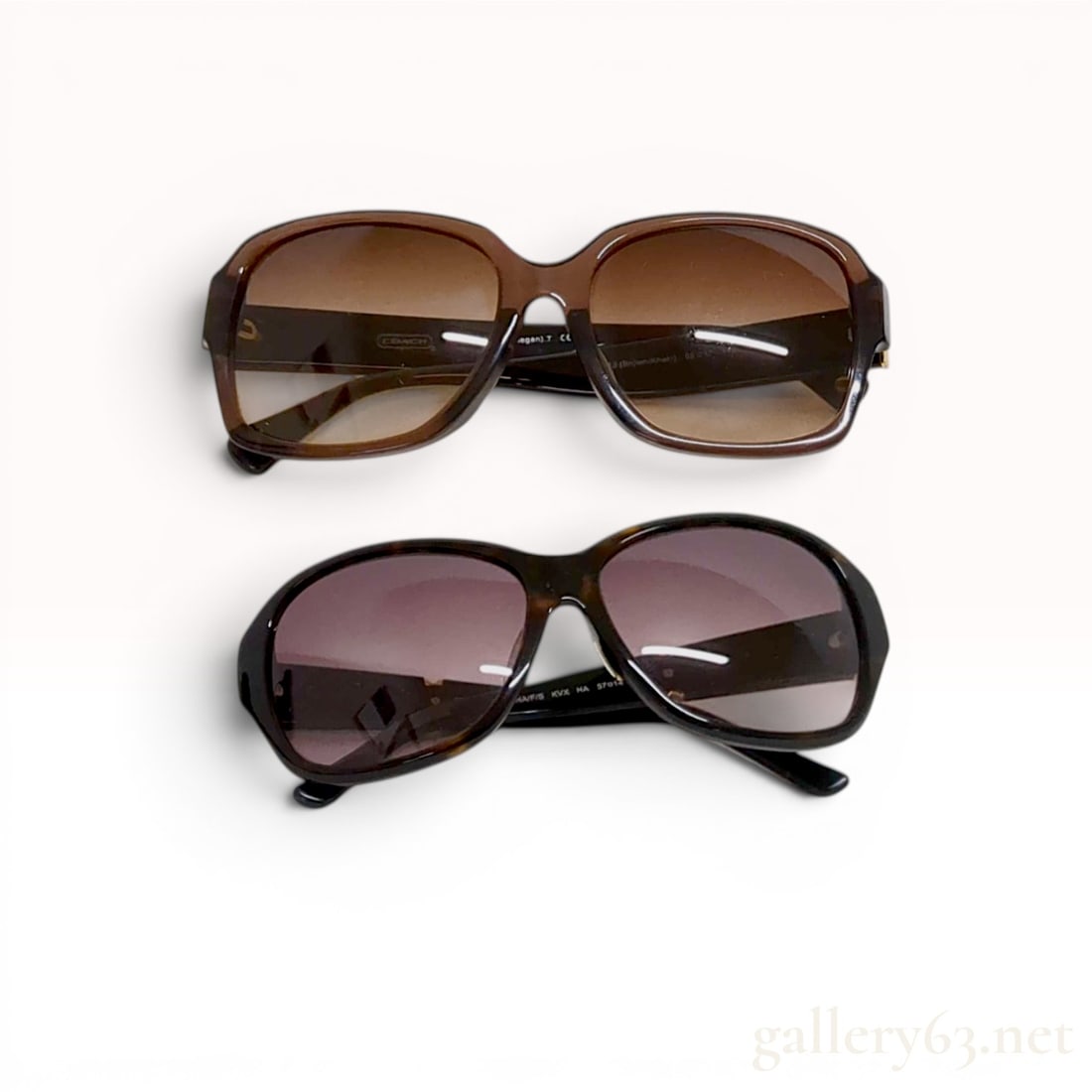 Two Pairs of Designer Sunglasses, Coach and Kate Spade New York: Two pairs of designer sunglasses by Coach and Kate Spade New York. The Coach Megan (HC 8044F) pair features dark brown rectangular frames with brown gradient lenses and signature logo patterned temple