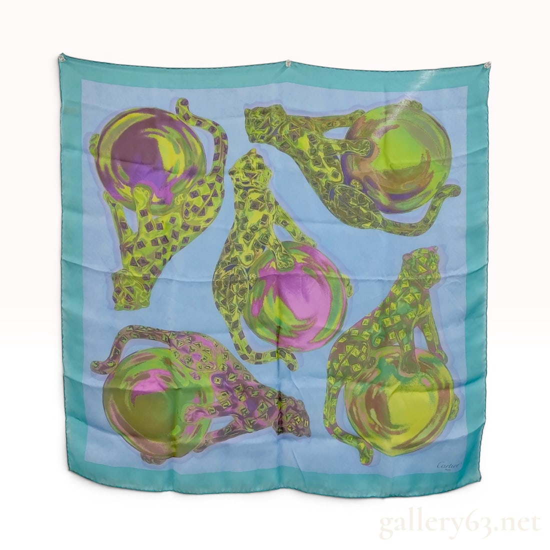 Cartier Panthere Motif Silk Scarf: Cartier silk scarf featuring the iconic Panthère motif, late 20th century. Screen-printed 100% silk with five stylized panthers and iridescent spheres in lime green and magenta on a pale blue f