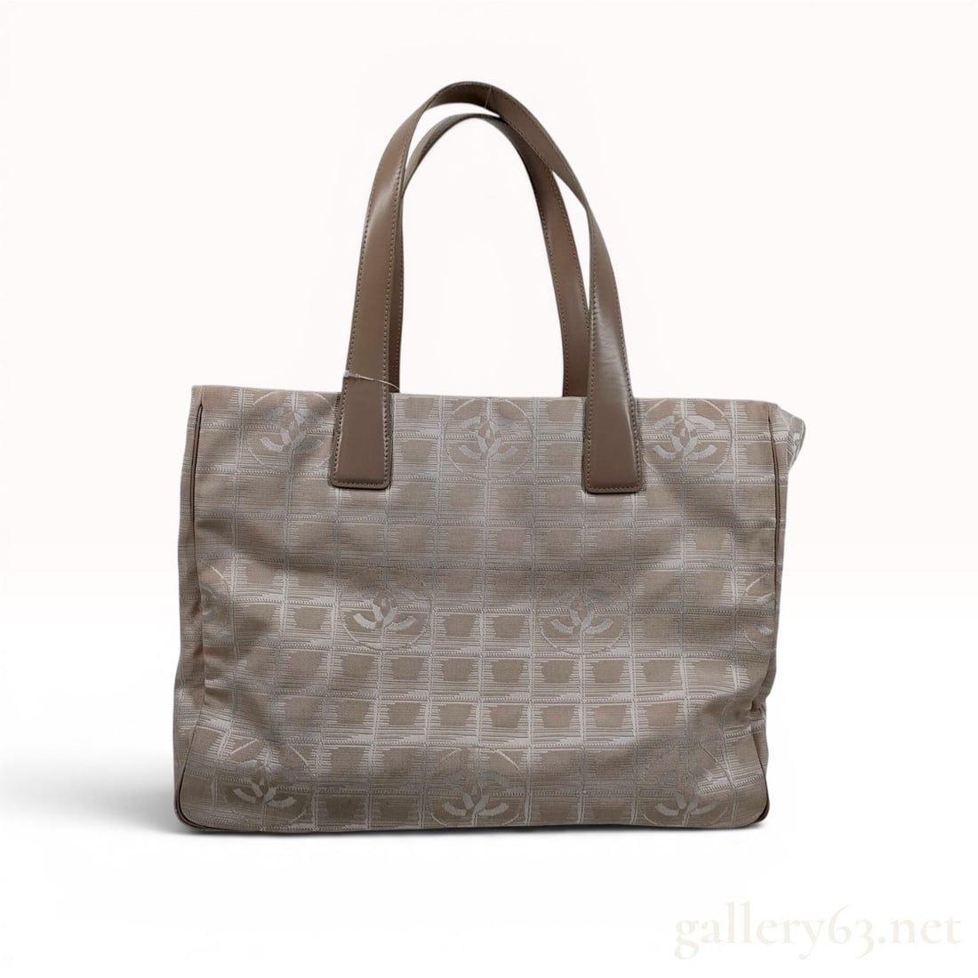 Chanel New Travel Line MM Tote Bag in Beige Jacquard: Chanel New Travel Line MM tote bag in beige nylon jacquard with a tonal interlocking CC logo and grid pattern. Construction includes two flat leather shoulder straps, an open top, and four protective 