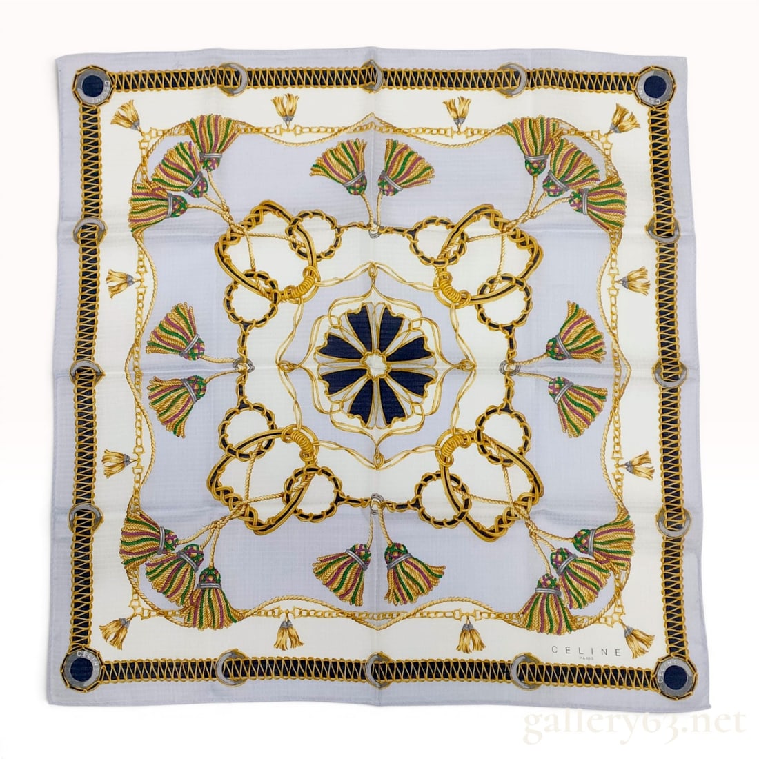 Celine Silk Scarf with Equestrian Tassel Design: Celine Paris silk scarf featuring an equestrian-inspired motif with multi-colored tassels and interlocking rope chains on a light blue and ivory ground. The central design includes a navy and gold geo