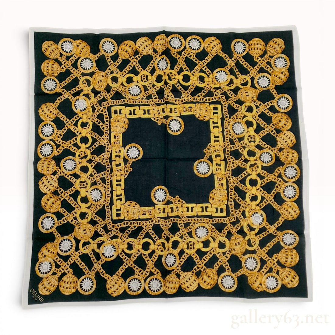 Celine Paris Gold Chain Motif Square Scarf: Celine Paris square scarf featuring an ornate gold chain jewelry motif on a black ground with a white border. The printed design includes interlocking circular and flat links, a central rectangular li