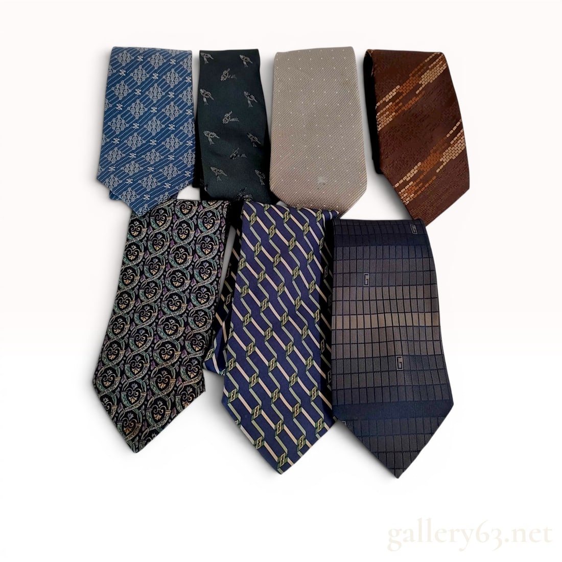 A Lot of Seven Designer Silk Neckties including Gucci, Fendi, and Christian Dior: A lot of seven designer silk neckties from luxury houses including Gucci, Fendi, Christian Dior, Celine, and Burberry. The collection features various woven and printed patterns such as a Gucci tonal 