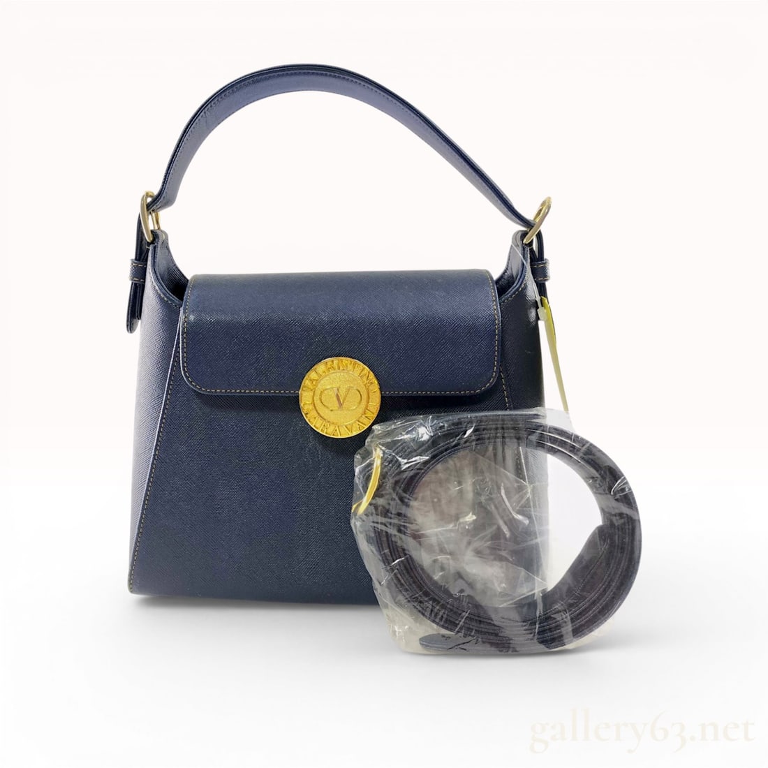Valentino Garavani Vintage Navy Saffiano Leather Top Handle Bag: A vintage structured handbag by Valentino Garavani crafted from navy blue Saffiano leather with prominent yellow contrast stitching. The exterior features a single flat top handle secured by gold-tone
