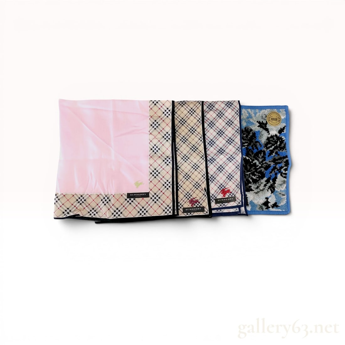 A Set of Four Burberry and Feiler Cotton Pocket Squares: A group of four cotton pocket squares by Burberry and Feiler, late 20th to early 21st century. The collection includes three Burberry pieces in various Nova check patterns with embroidered equestrian 