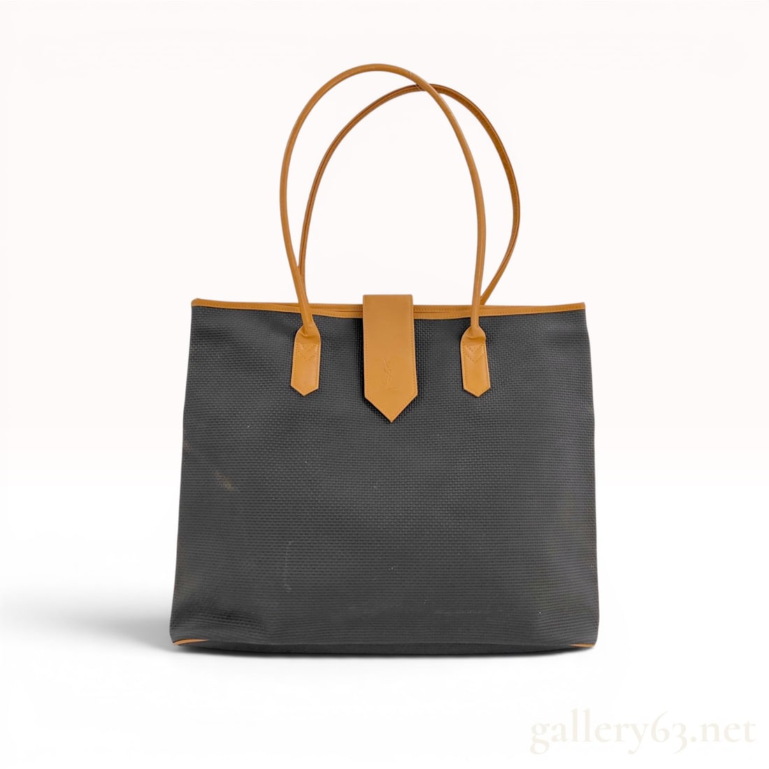 Yves Saint Laurent Logo Tote Bag: Yves Saint Laurent tote bag, late 20th century. Crafted from dark grey textured woven fabric with tan leather trim, piping, and dual thin rounded shoulder straps. Features a central tan leather tab cl