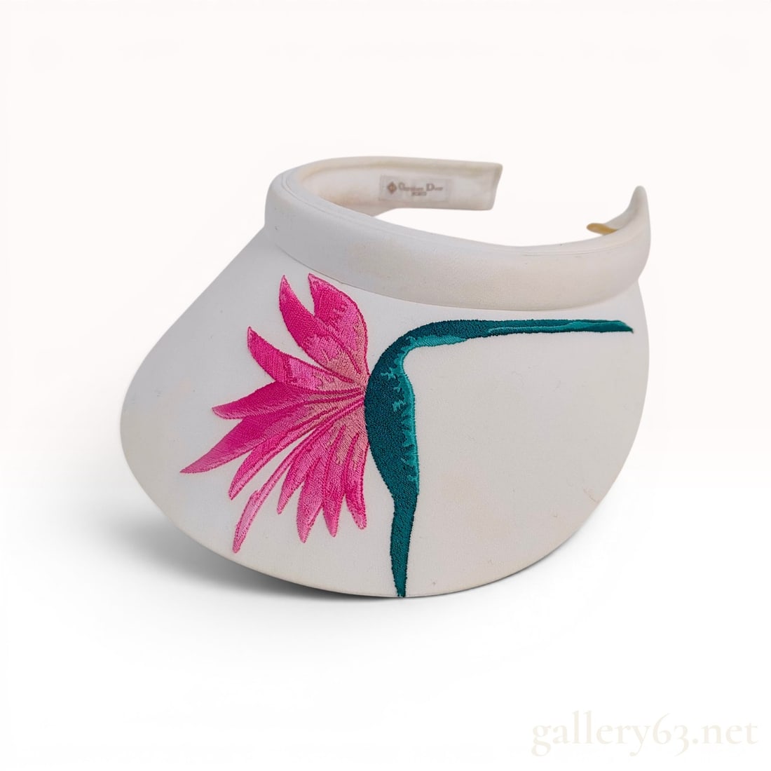 Christian Dior Sports Embroidered Floral Motif Sun Visor: Vintage Christian Dior Sports sun visor, late 20th century. White synthetic fabric exterior features a large embroidered fuchsia pink flower with a long teal green stem. The clip-on style accessory is