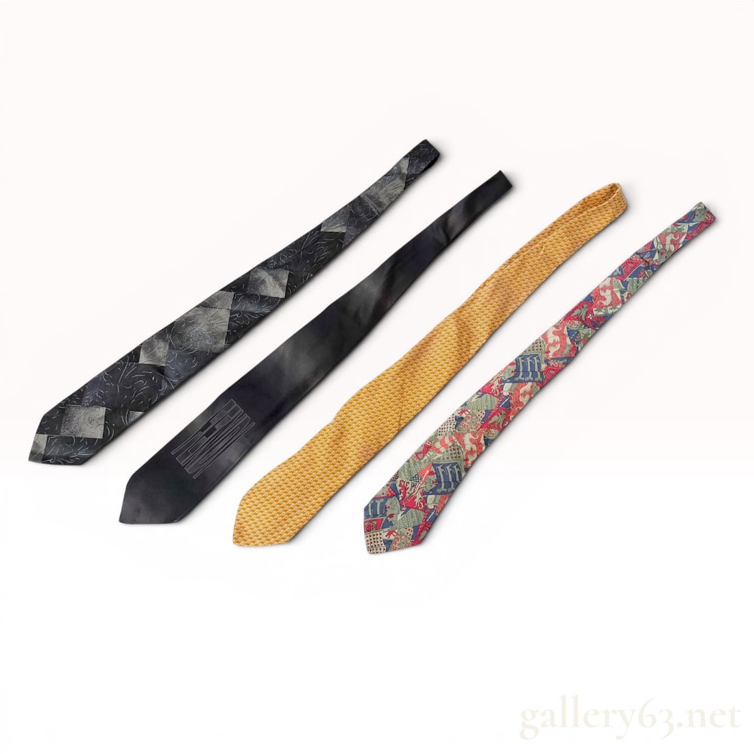 A Collection of Designer Silk Neckties including Hermes, Ferragamo, Versace, and Fendi: A collection of silk neckties from European fashion houses including Hermes, Salvatore Ferragamo, Gianni Versace, and Fendi. The assortment features a Hermes heraldic print tie in shades of red, blue,