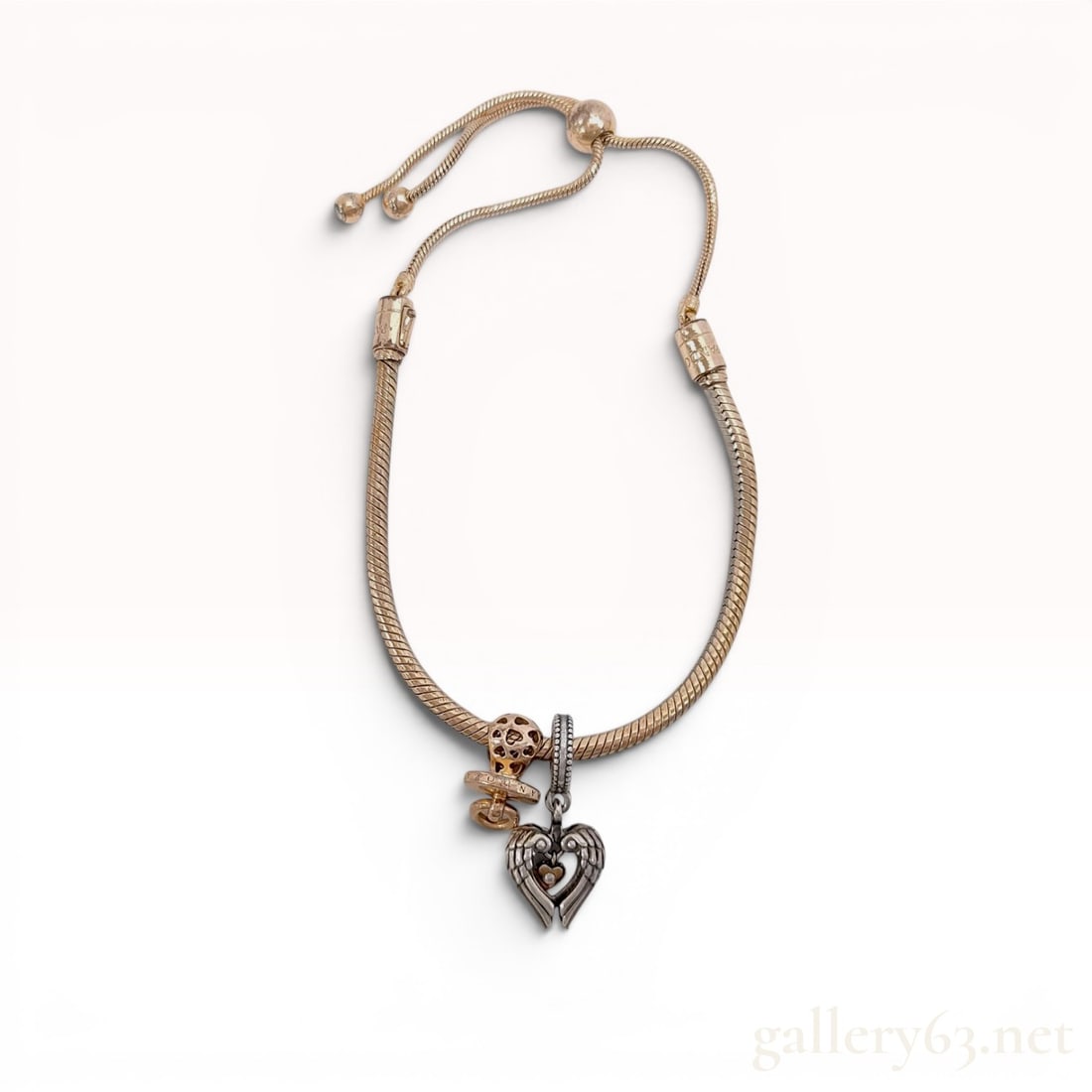 Pandora Rose Gold-Tone Adjustable Slider Charm Bracelet with Two Charms: Pandora Moments adjustable snake chain bracelet in rose gold-tone finish featuring two charms. Included is a two-tone silver and rose gold-tone Pandora Club 2021 Angel Wings and Heart dangle charm wit