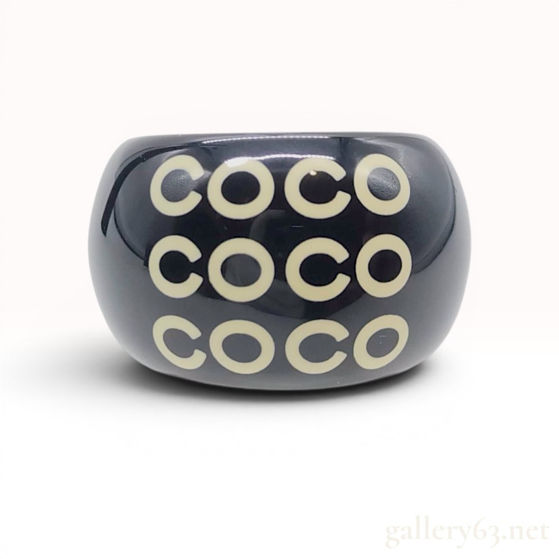 Chanel Vintage COCO Black Resin Cuff Ring, Spring 2001 Collection: Chanel wide open-back resin ring from the Spring 2001 collection featuring a polished black body with cream-colored COCO lettering in three rows. The design includes a white interlocking CC logo on th