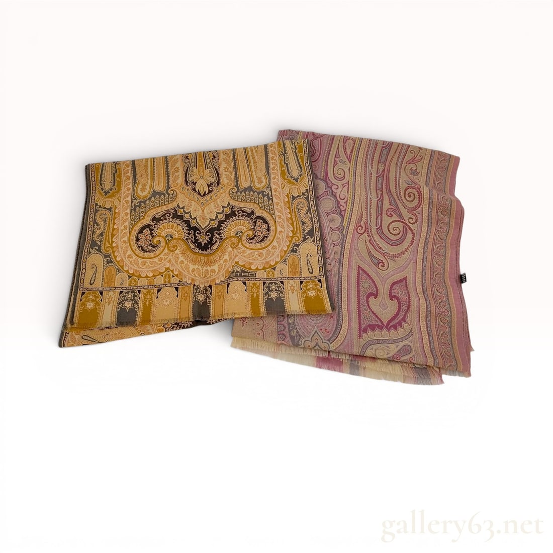 A Set of Two Etro Paisley Print Cashmere and Silk Scarves: A set of two Etro scarves featuring intricate paisley motifs, made in Italy. One scarf is designed in a palette of mustard yellow, ochre, and charcoal grey, while the other features tones of dusty ros