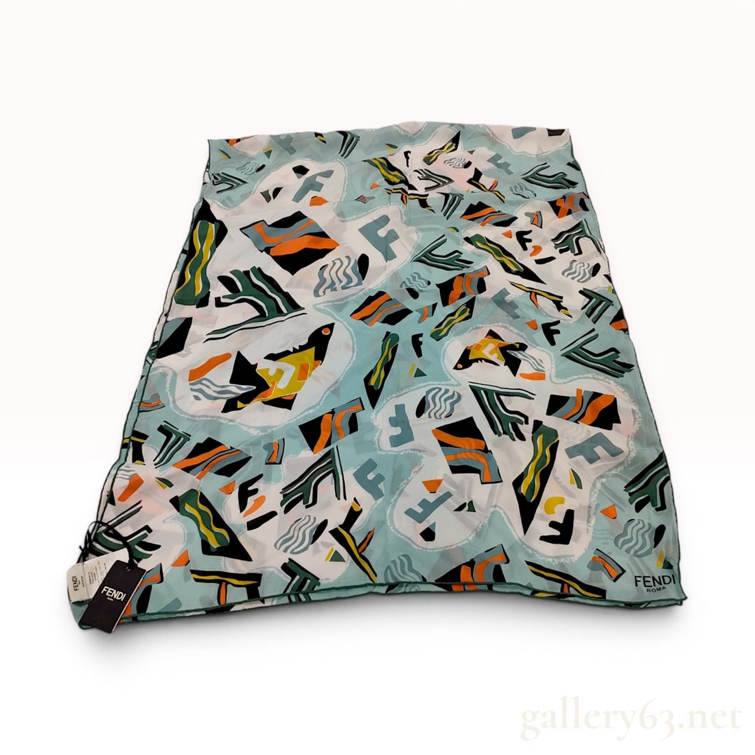 Fendi Roma Silk Stole with Abstract Geometric Pattern new with Tags: Fendi Roma silk stole featuring a multi-color abstract geometric pattern on a light teal ground with stylized logos. Constructed from 100% silk with a hand-rolled green hem, accompanied by an original