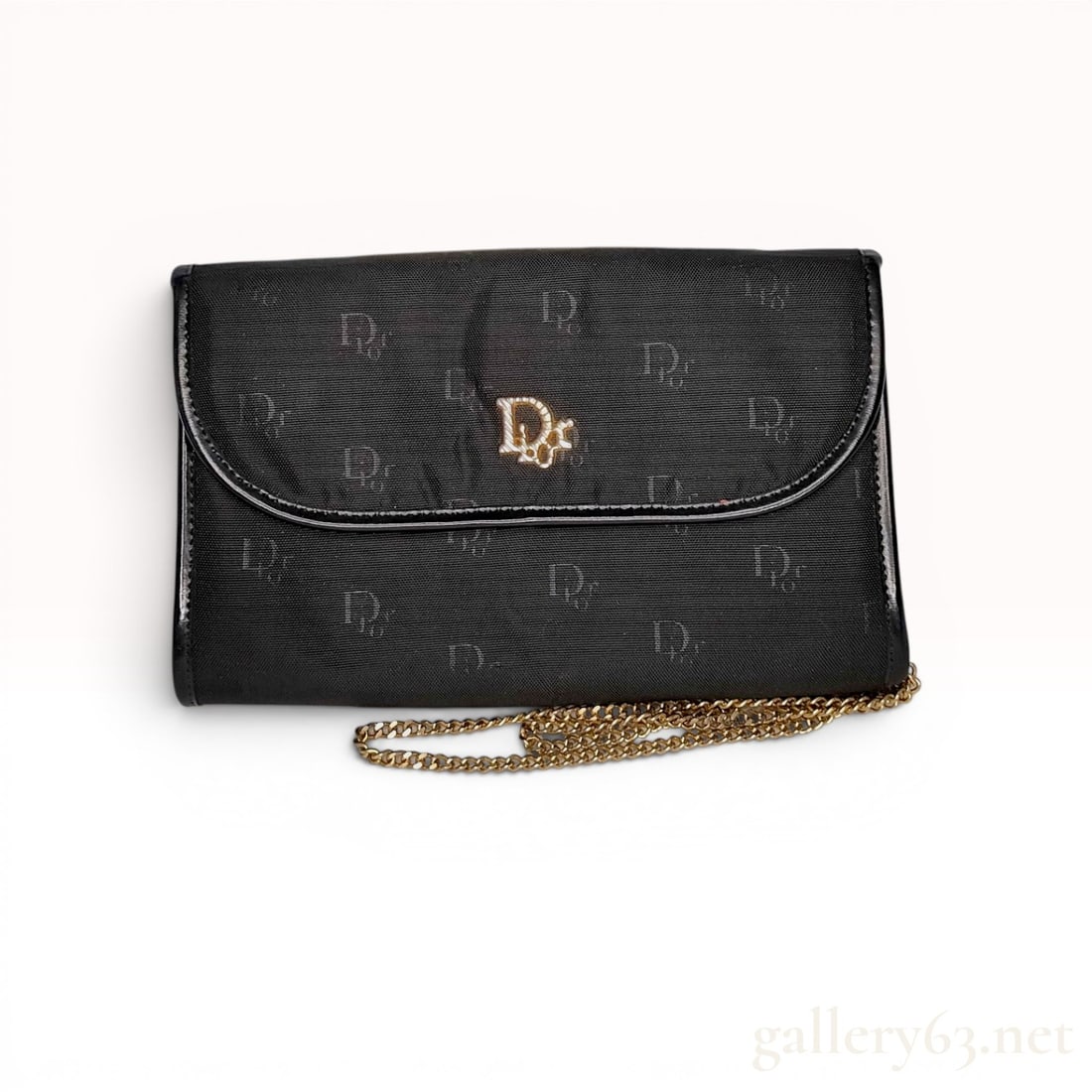Christian Dior Vintage Black Monogram Jacquard Chain Clutch: Christian Dior vintage evening bag crafted from black monogram jacquard fabric with smooth leather trim, circa 1970s-1980s. The structured design features a rounded front flap accented with a gold-ton