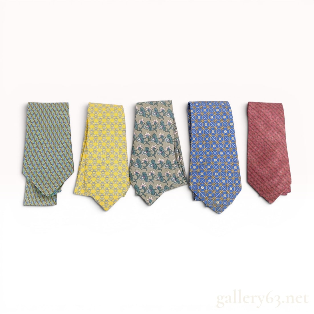 An Assortment of Men's Silk Designer Neckties Including Hermes and Chanel: An assortment of woven silk designer neckties including pieces by Herm?¨s and Chanel. The collection features stylized equestrian, interlocking CC floral, and geometric patterns. Marks include printe