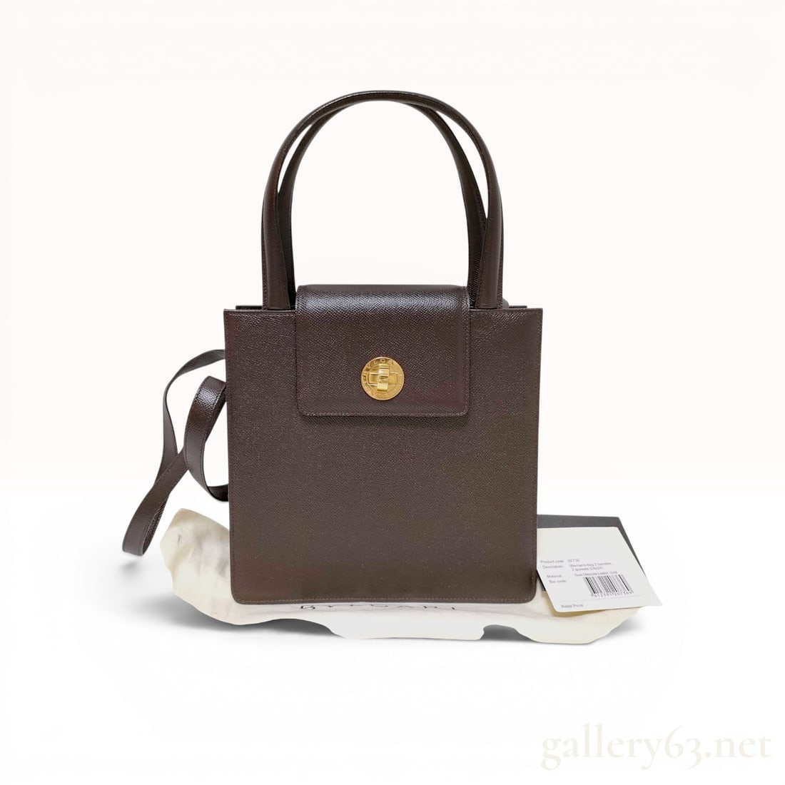 Bvlgari Structured Chocolate Brown Grained Leather Top Handle Bag: Bvlgari structured top handle bag crafted in chocolate brown grained leather with gold-tone hardware. This vintage design features dual rolled leather handles, a removable adjustable shoulder strap, a