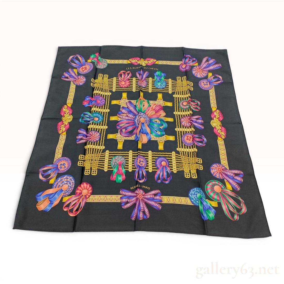 Hermes Les Rubans du Cheval Silk Scarf: Hermès silk twill scarf in the Les Rubans du Cheval pattern, originally designed by Joachim Metz and first issued in 1988. The design features a black ground decorated with multicolored prize r