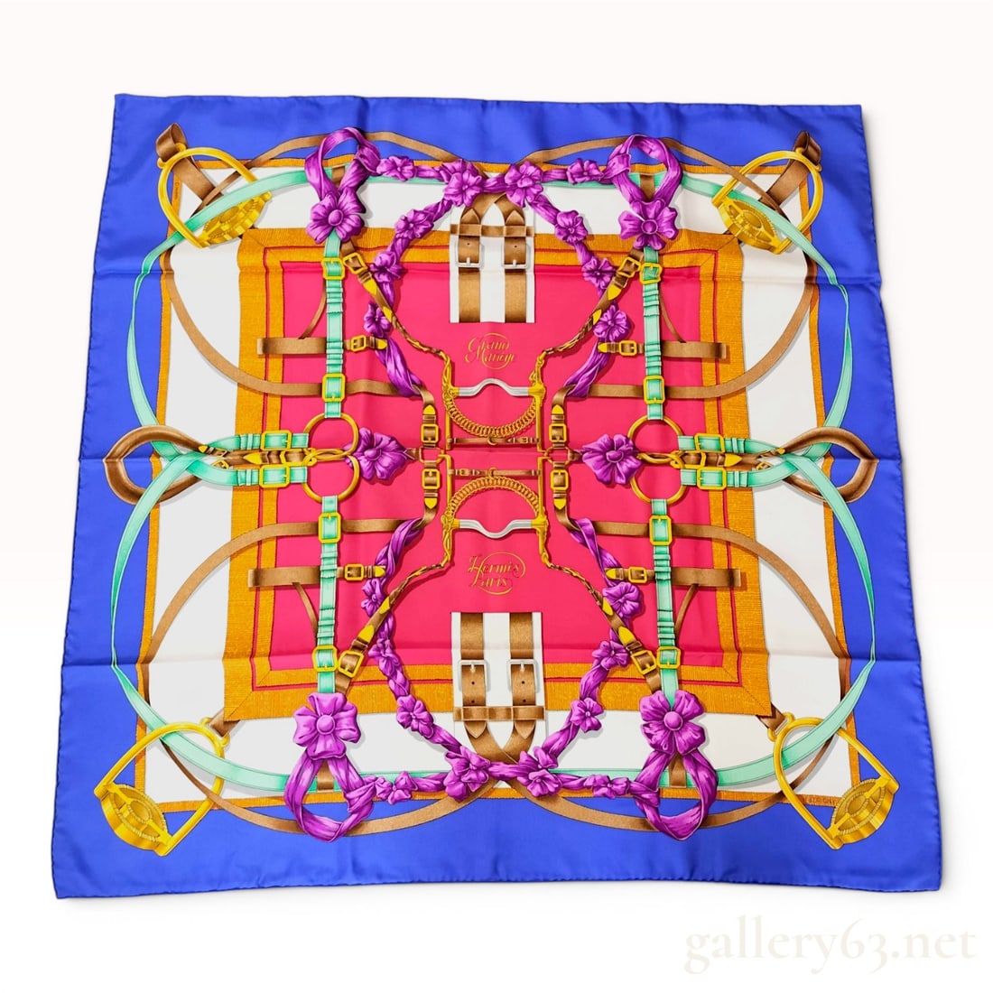 Hermes Grand Manege Silk Scarf by Henri d'Origny w/Box: Hermes 90cm silk carre in the Grand Manege pattern, designed by Henri d'Origny and first issued in 1990. The equestrian-themed composition features bits, stirrups, and bridles intertwined with purple 