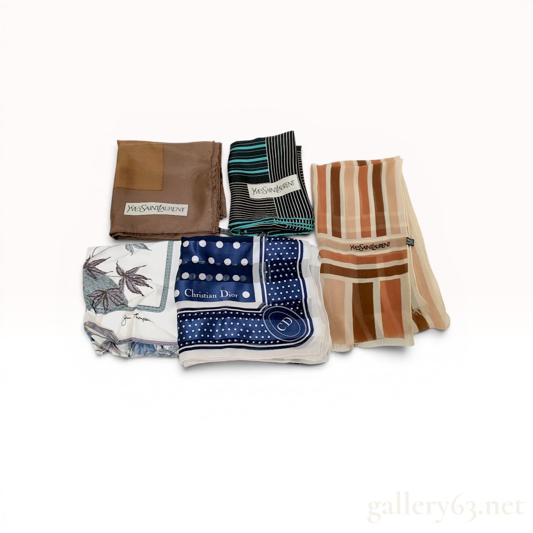 A Collection of Five Designer Silk Scarves Including Yves Saint Laurent, Christian Dior, and Jim: A collection of five designer silk scarves from Yves Saint Laurent, Christian Dior, and Jim Thompson, late 20th century. The set features varied patterns including geometric color blocks, stripes, and