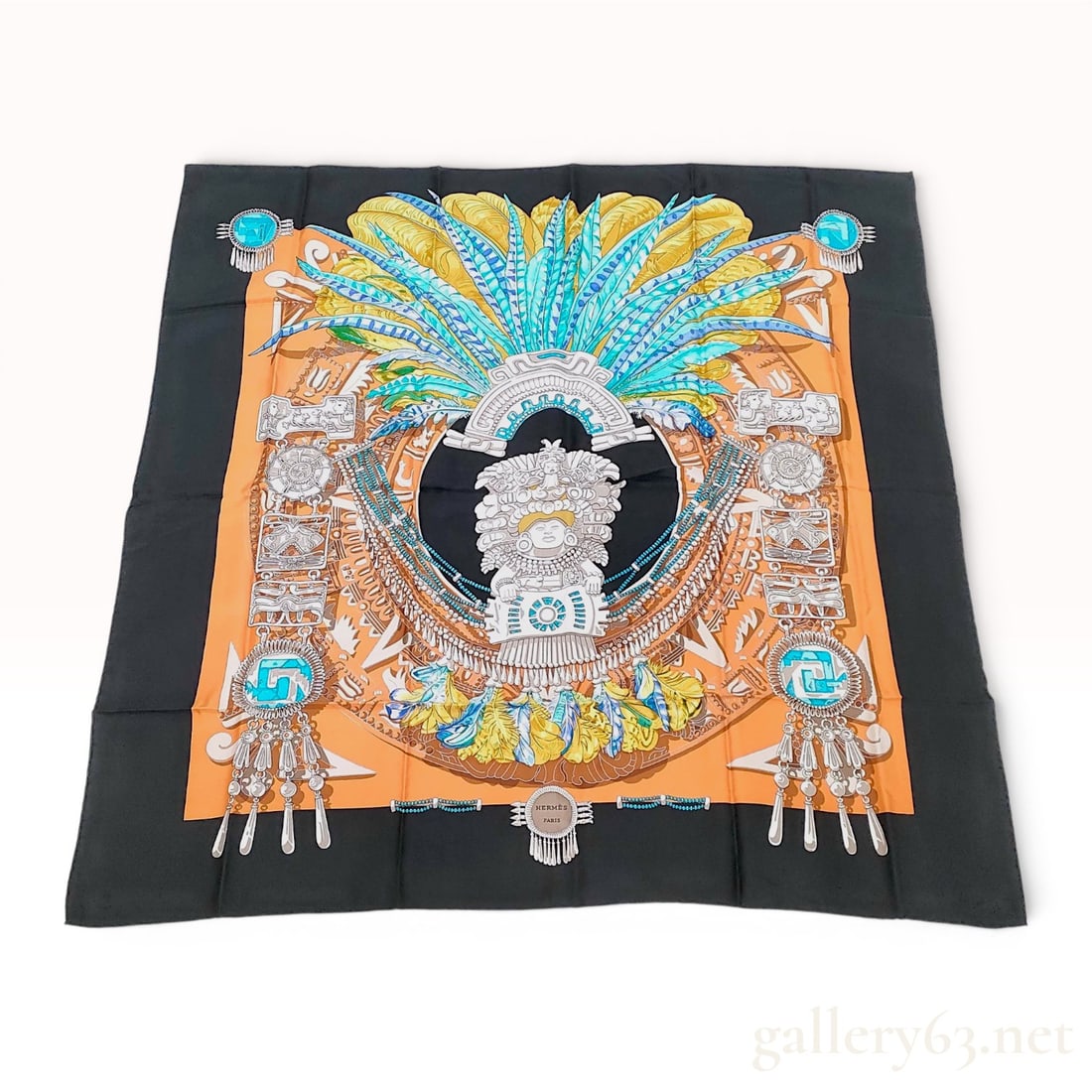 Hermes Silk Twill Scarf in the Mexique Pattern by Cathy Latham: Hermès silk twill scarf in the Mexique pattern designed by Cathy Latham, first issued circa 1985. The elaborate design features a central Mesoamerican quetzal feather headdress surrounded by st