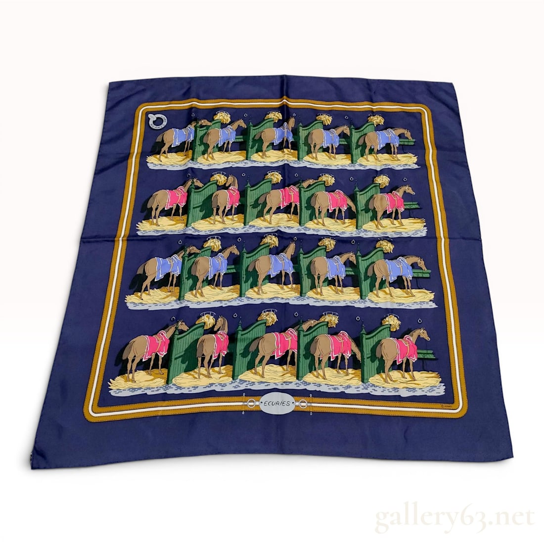 Hermes Hugo Grygkar Ecuries Pattern Silk Scarf: Hermès silk twill carre in the Ecuries pattern, originally designed by Hugo Grygkar. The navy blue field displays a repeating motif of horses in individual green stalls with alternating pink an
