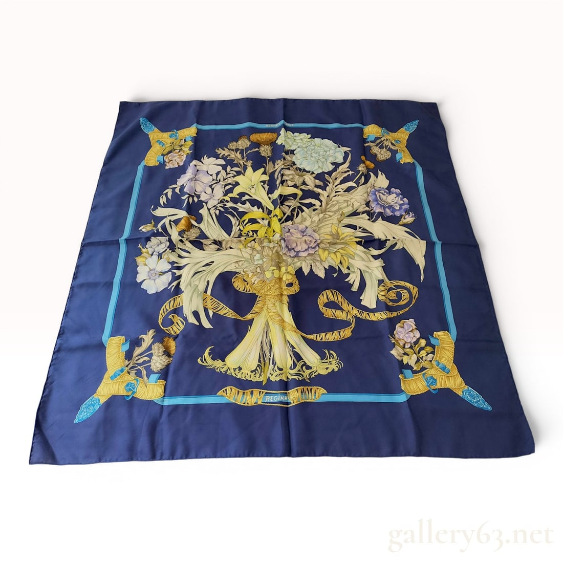 Hermes Regina Silk Scarf by Leila Menchari: Hermès silk twill scarf in the Regina pattern designed by artist Leila Menchari, first issued in 1972. The design features a large central bouquet of lilies, carnations, and anemones tied with 
