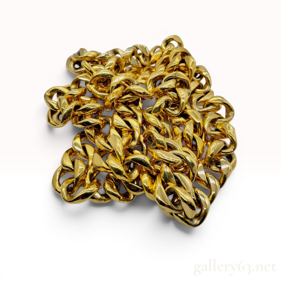 Chanel Vintage Gold-Toned Curb-Link Chain Belt: Chanel vintage chunky curb-link sautoir necklace or belt, late 20th century. The piece is composed of heavy gold-toned metal links with a polished finish and features a hook-and-eye clasp. One link is
