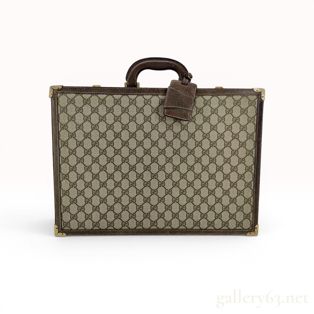 Vintage Gucci Monogram GG Supreme Hardside Attache Briefcase: This vintage Gucci hardside attache briefcase is constructed from GG Supreme monogram coated canvas in a beige and ebony color palette. The exterior features dark brown leather trim and a leather-wrap