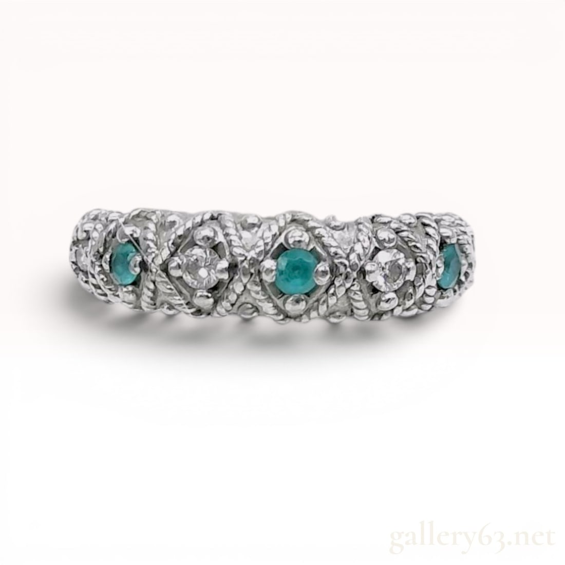 Platinum, Neon Paraiba Tourmaline and Diamond Band: Platinum decorative band-style ring featuring alternating paraiba tourmaline and diamonds. The design includes three round faceted neon blue-green paraiba tourmaline and four small round brilliant-cut