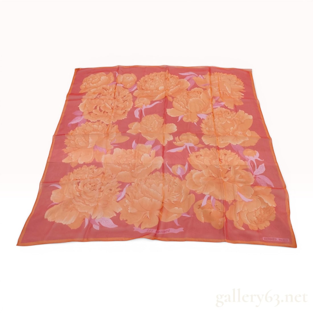 Hermes Les Pivoines Silk Mousseline Scarf w/Box: Hermès silk mousseline scarf in the Les Pivoines pattern, late 20th century. The design features large peony blossoms in orange and pink tones on a coral-red ground with hand-rolled hems and a 