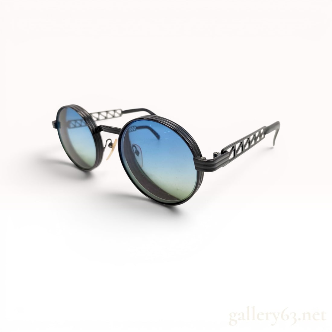 Jean Paul Gaultier Model 56-0103 Vintage Round Metal Sunglasses: Jean Paul Gaultier model 56-0103 vintage sunglasses, circa late 1980s to early 1990s. Construction features a black-finished metal frame with round, stepped double-rims, openwork geometric truss templ