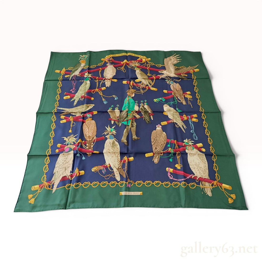Hermes Les Oiseaux du Roy Silk Scarf: Hermès silk twill scarf titled Les Oiseaux du Roy, designed by Henri de Linarès. The falconry-themed pattern features a central falconer and various hooded birds of prey on a navy blue f