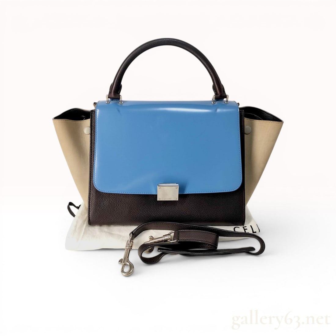 Celine Tricolor Medium Trapeze Top Handle Bag: A Celine Medium Trapeze handbag featuring a tri-color and tri-material design. The construction includes a smooth blue leather front flap, a dark brown pebbled leather main body and top handle, and ta
