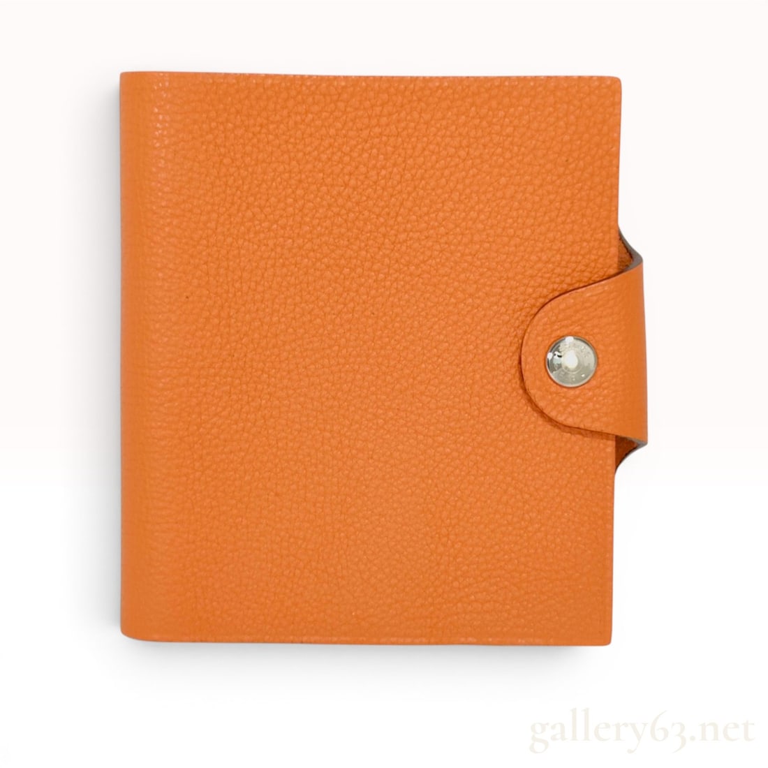 Hermes Orange Leather Ulysse Mini Notebook Cover with Notebook!!: Hermès Ulysse Mini notebook cover in signature orange pebbled leather with a silver-tone snap closure. The interior features a suede-finished leather lining and includes a spiral-bound notebook