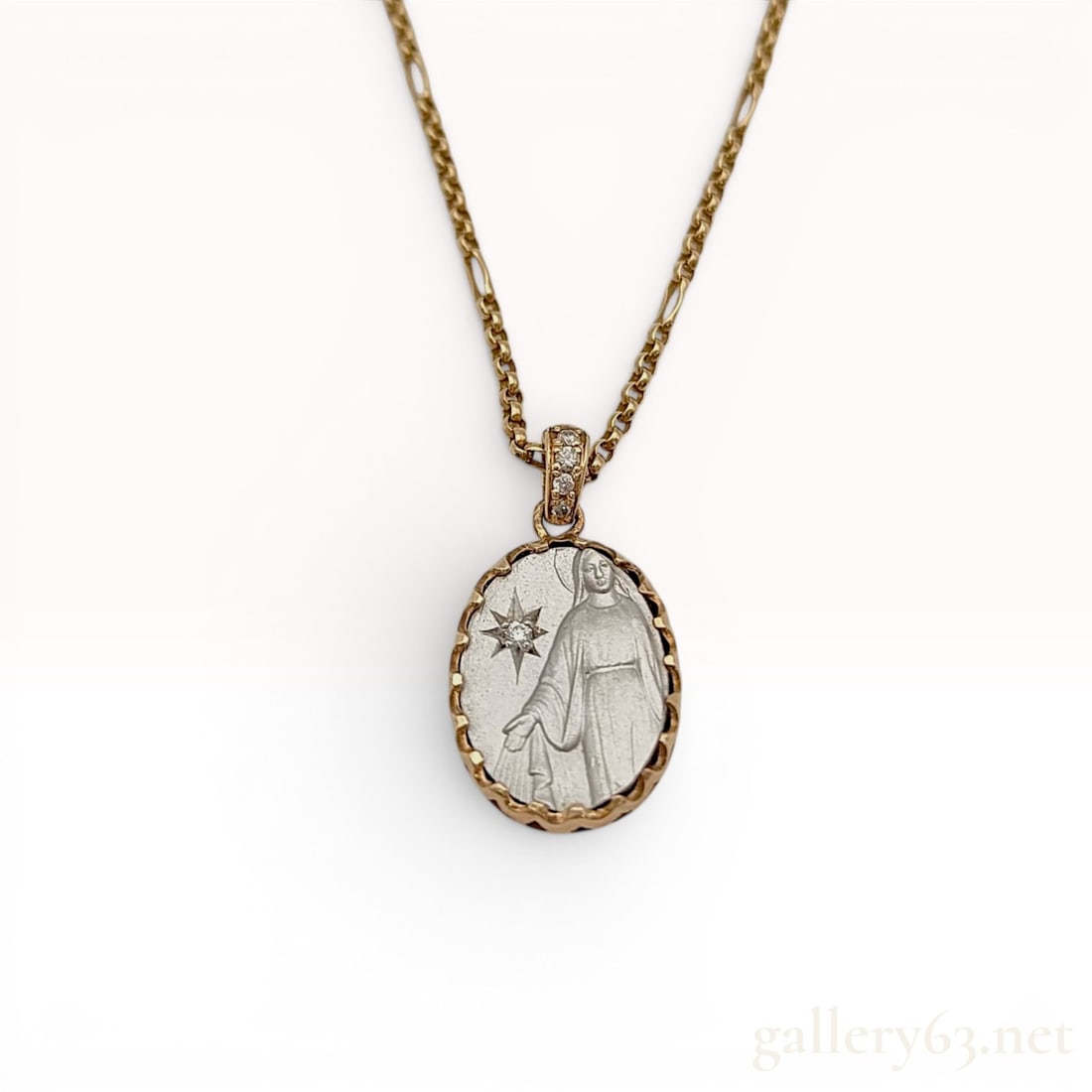 203 Jewelry 10K Two-Tone Gold and Diamond Mother Mary Pendant Necklace: A contemporary religious medallion necklace by the brand 203 Jewelry. The oval pendant features a white-toned metal relief of the Virgin Mary set within a 10K yellow gold scalloped frame. The obverse 