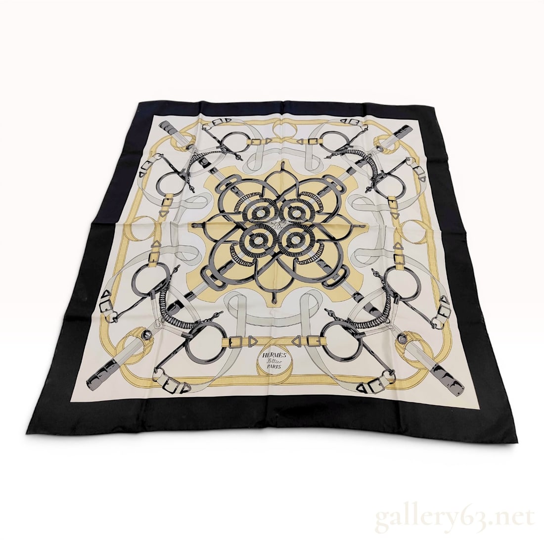 Hermes Silk Carre 90 Scarf in Sellier Pattern: Hermès silk Carre 90 scarf featuring the Sellier equestrian pattern. The 100% silk twill design displays a symmetrical arrangement of horse bits, curb chains, and leather harnesses in ivory, go