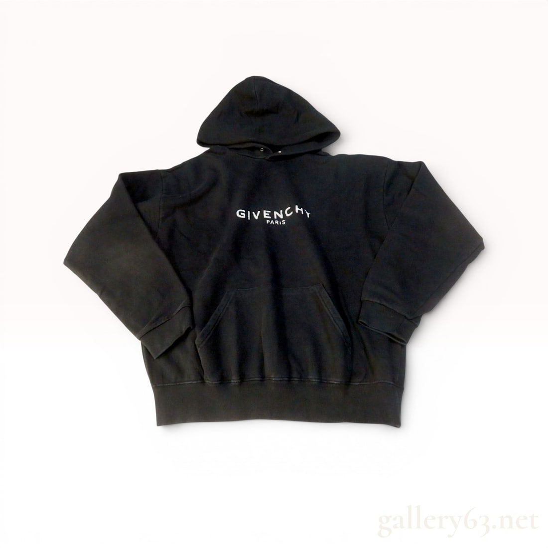 Givenchy Black Distressed Logo Cotton Hoodie size Large: Givenchy black cotton pullover hoodie, contemporary. Features a distressed white "GIVENCHY PARIS" logo on the chest, a front kangaroo pocket, and ribbed cuffs and hem. Interior labels include a woven 