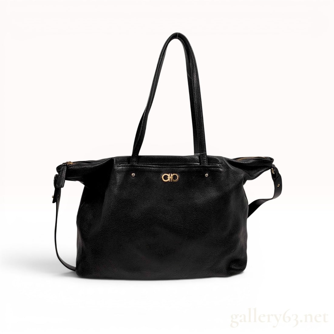 Salvatore Ferragamo Large Mika Tote in Black Pebbled Leather: Salvatore Ferragamo Large Mika tote bag crafted from black pebbled calfskin leather. The design features a signature gold-tone metal Gancini logo on the front face, dual flat leather shoulder straps, 