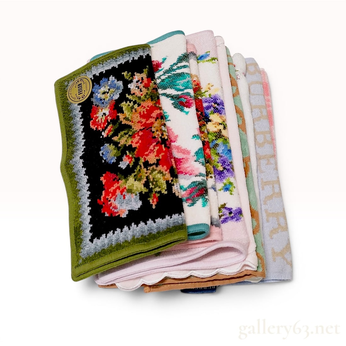 A Collection of Designer Pocket Squares and 45cm Scarves Including Burberry, Vivienne Westwood: An assortment of designer pocket squares and small towels from makers including Feiler, Vivienne Westwood, Burberry, Wedgwood, Bally, and Ralph Lauren. The pieces feature various floral, geometric, an